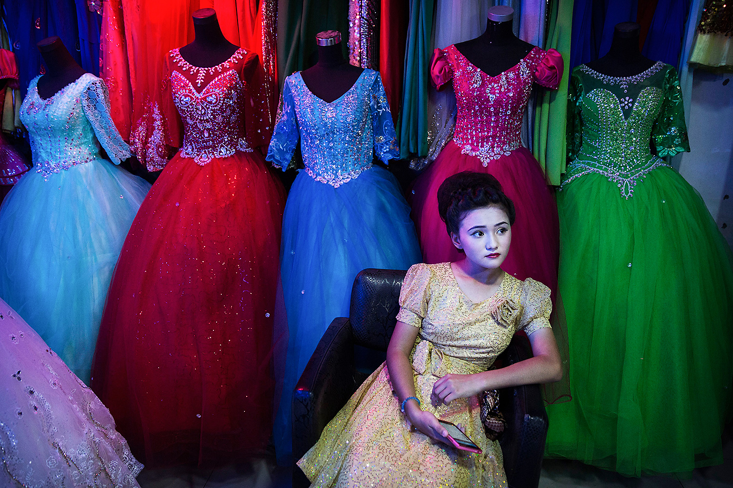 An ethnic Uighur girl waits in a beauty salon to have her hair done before the Corban festival known elsewhere as Eid al-Adha, or “feast of the sacrifice,” in Turpan County, Xinjiang. Though Islam is one of five “officially recognized” religions in China, local officials often severely restrict Uighurs’ ability to practice their faith. These restrictions, as well as ethnic tensions, have fueled violence in Xinjiang and across China—violence that Beijing uses to justify further repression. Photo by Kevin Frayer @kevinfrayer