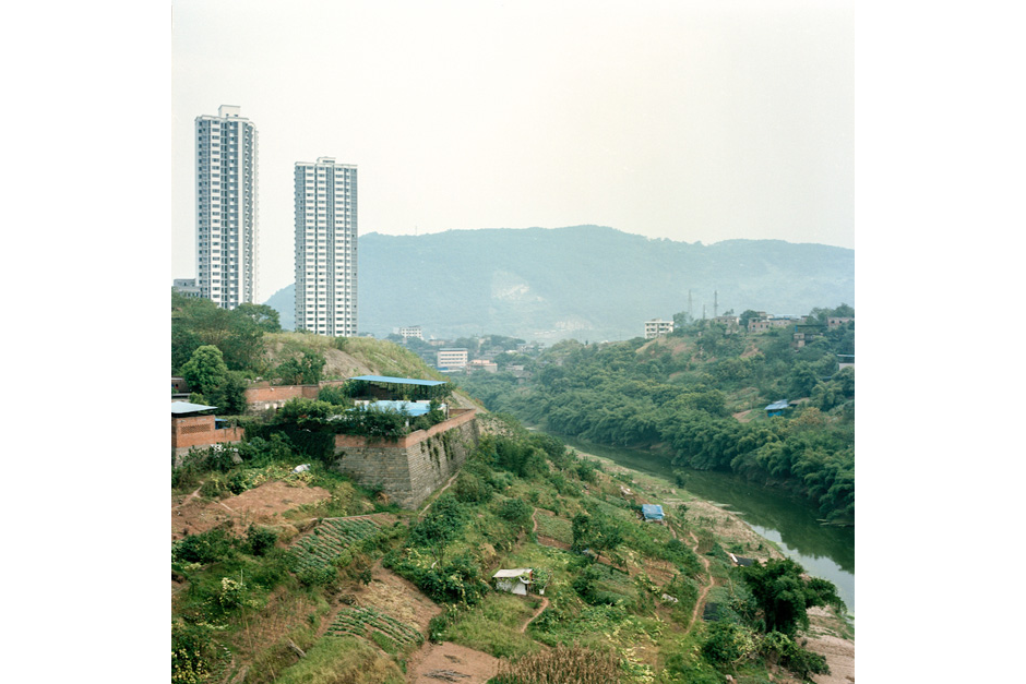 In the Jiangbei district of Chongqing, just downstream of where the Jialing River joins the Yangtze, the city is pushing for more urban development. Farmers, relocated to the city due to the construction of the Three Gorges Dam hundreds of miles downriver, seek cultivable land on hillsides and active construction sites.