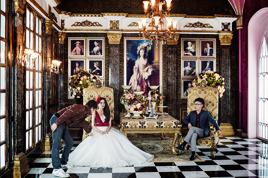 Cheng, twenty-eight, and her fiance Zhang, thirty-three, prepare for a shoot on the Versailles set at The Only Photo Studio. The basic package, costing 3,000 RMB, comes with six outfit changes and six setting choices.