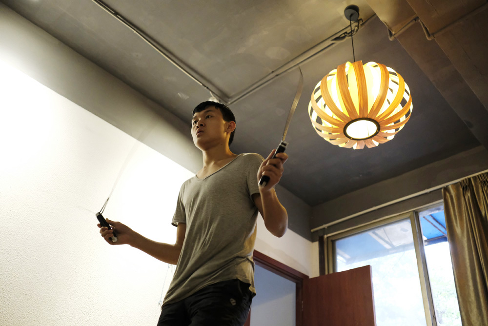 Xia trains by skipping rope in his dormitory.