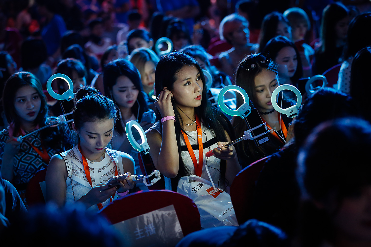 Aspiring Internet celebrities (a.k.a. hostesses) attend a product release presentation at a conference in Beijing. Every month, more than 85 million people watch live broadcasts on cellphone apps, according to QuestMobile. Photo by Liu Xingzhe @liuxingzhe