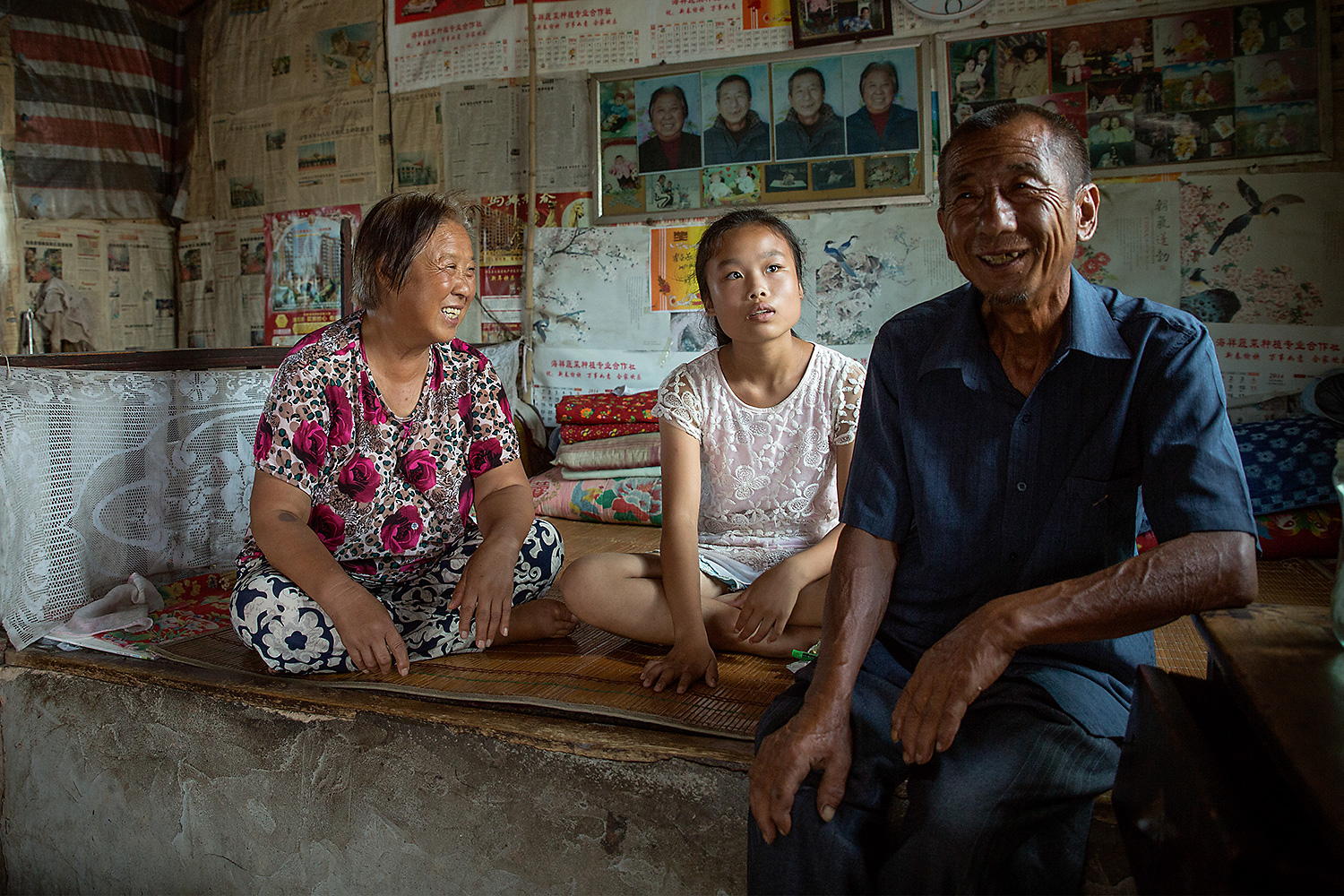 Swallow, 14, sits with her caretakers, her grandfather and his partner, in their home. Her father died in an accident when she was younger and her mother lives and works in Yuncheng, the closest biggest city, but never visits or contacts her. Swallow says her dream is to visit family in Yuncheng, less than 31 miles away. Swallow benefits from the support of one of China’s growing number of ‘Barefoot Social Workers’—community-selected individuals who are trained by UNICEF to provide child protection and welfare services in rural villages. Photo by Sharron Lovell @sharron_l / UNICEF China