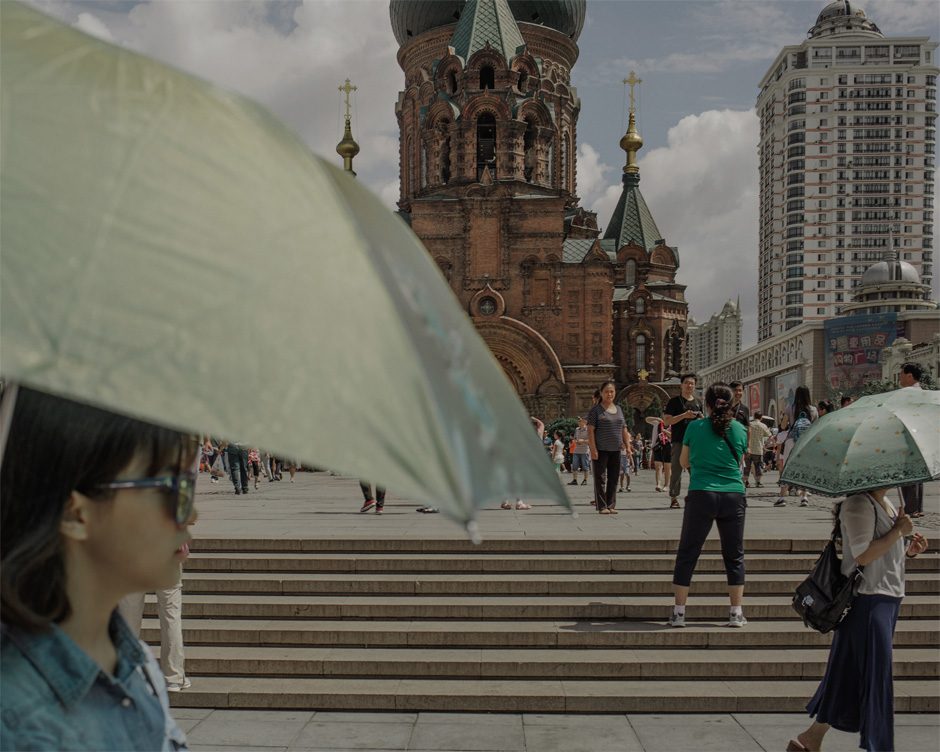 Visitors take pictures in front of Saint Sophia Cathedral in Harbin. The original church, built on this site in 1907 to mark the 1903 completion of the Trans-Siberian Railway, was constructed from timber. In the 1990s, the church was rebuilt, and it is now a tourist destination used primarily as a backdrop for wedding pictures.