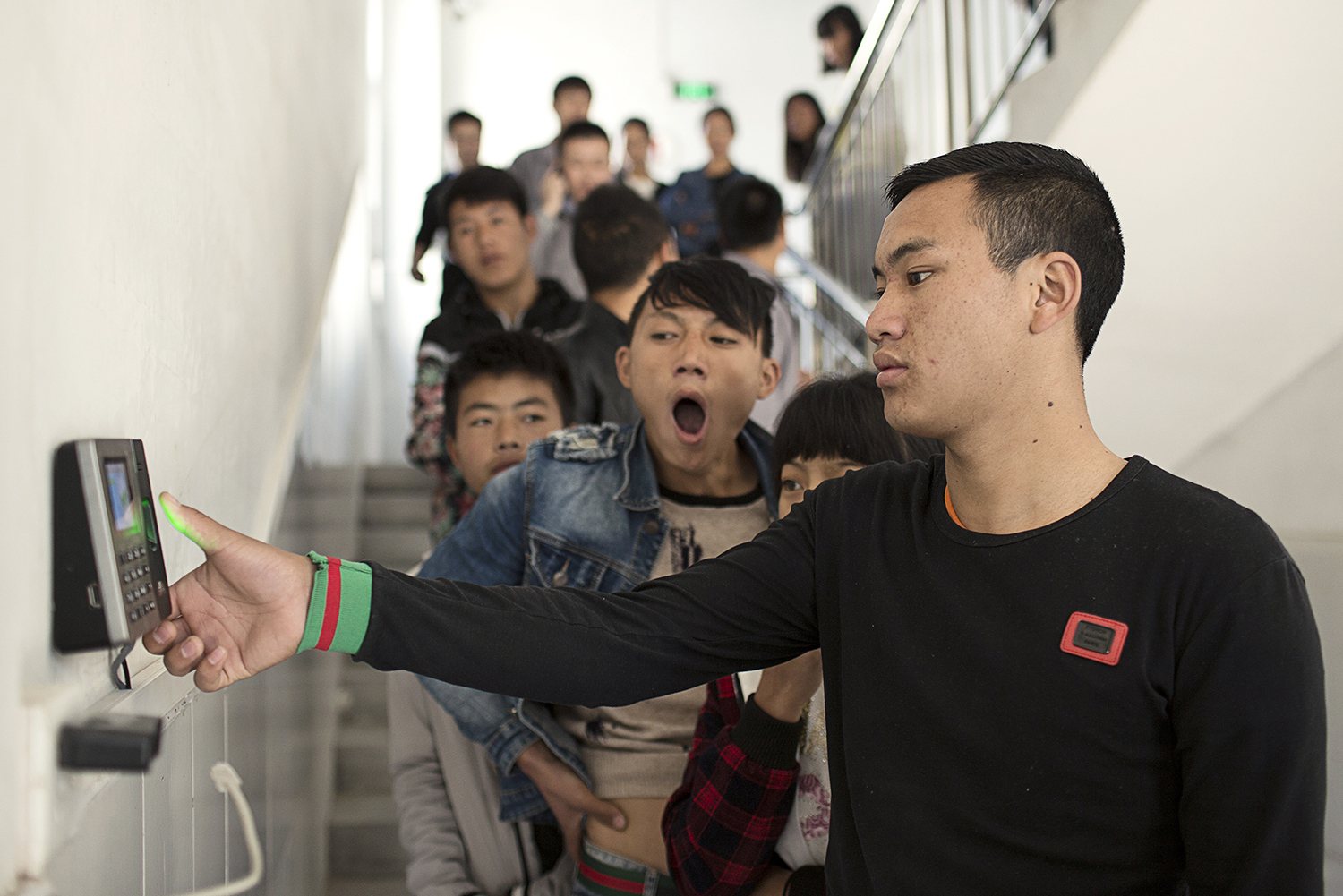 January 2, A Xia (front) and his coworkers, all members of the Yi minority from the Liangshan region of Sichuan, start their first day of work at an electronic device factory in Shenzhen. There are now an estimated 300,000 Yi workers in the Pearl River Delta. (Zhou Qiang)