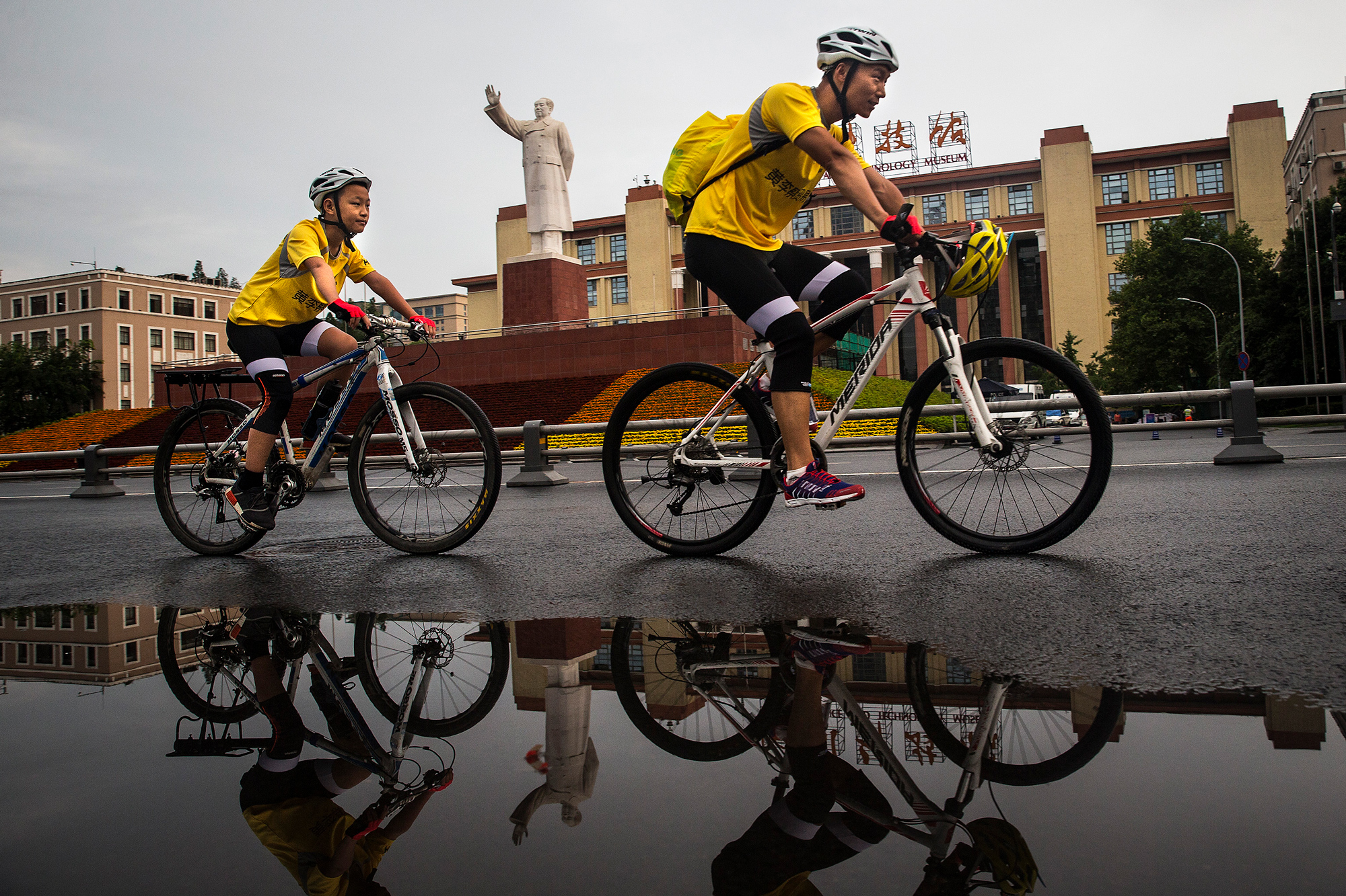 Wang Chao, 42, and his 12-year-old son, Runxi, kick off their Chengdu-Lhasa bike trip at Tianfu Square in Chengdu, Sichuan province, July 15, 2017. Over the next 23 days, the father and son will bike 1,300 miles along China National Highway 318, climbing 10 mountains with an elevation of more than 13,000 feet.