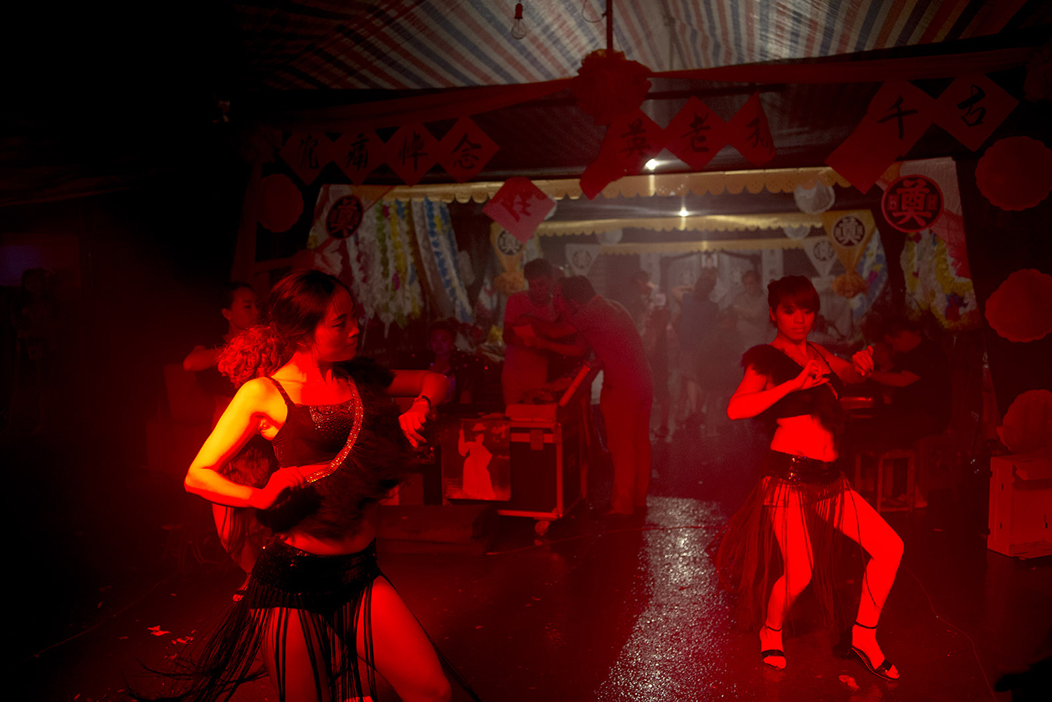 Dancers perform at a funeral in Wanzhou district of Chongqing municipality, July 23, 2014. 