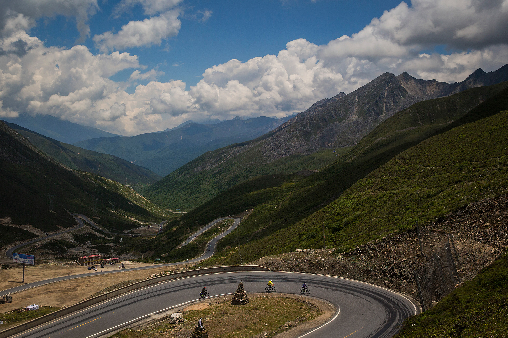 Chao and Runxi bike on 16,000-foot-high Mount Zheduo, in Garze Tibetan Autonomous Prefecture, Sichuan province, July 19. Their route crosses a pass at 14,071 feet.
