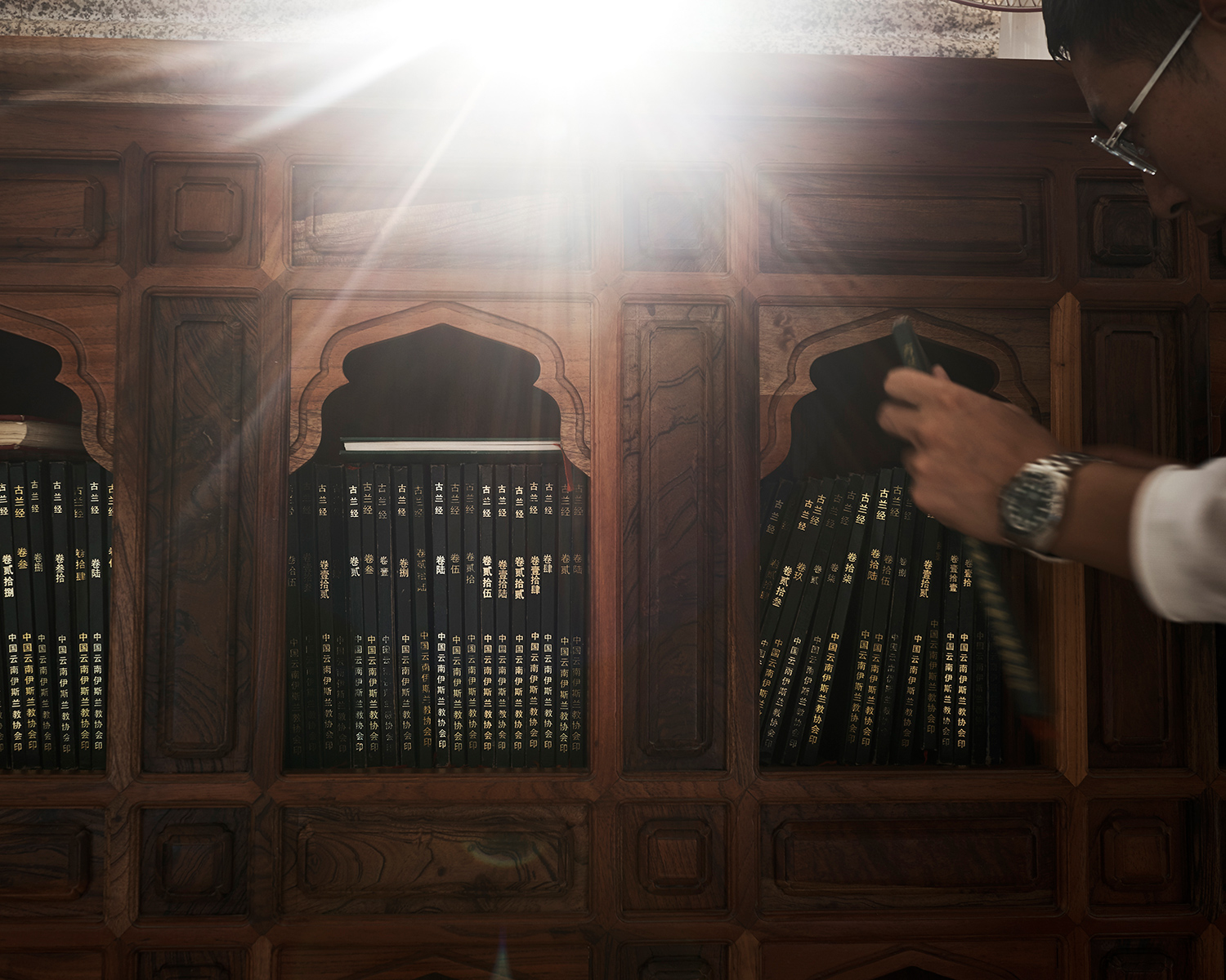 Umar, a Hui student born in 1992, picks up a chapter of the Quran at the Grand Mosque of Shadian, Yunnan province, June 2016. About 90 percent of Shadian’s residents are Hui. The Grand Mosque of Shadian is one of the biggest mosques in China. During the Cultural Revolution, the People’s Liberation Army raided the town and killed about 1,600 Hui people during a crackdown. Later on, the central government apologized and issued reparations. 
