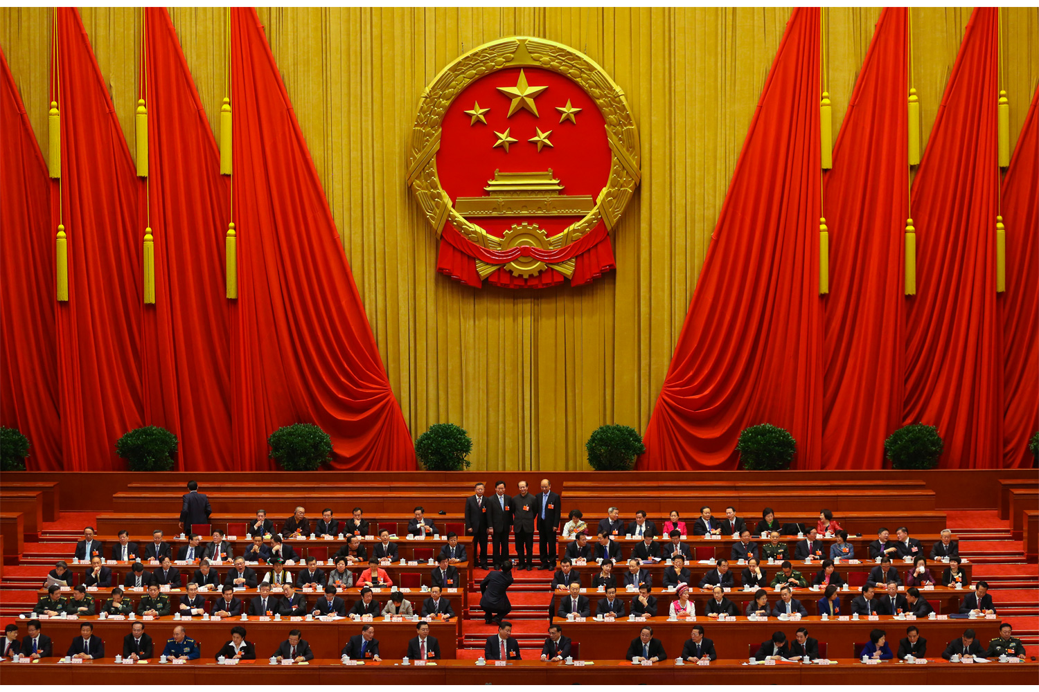 Deputies take a group photo on the rostrum inside the Great Hall of the People before the First Session of the 12th NPC begins, March 13, 2013. President Xi Jinping is seated in the first row, center.
