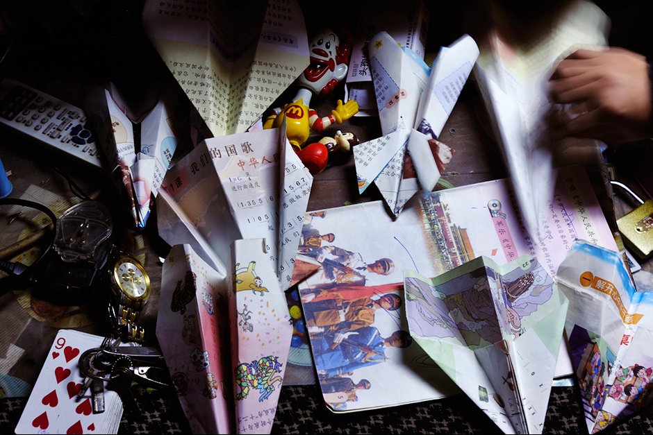 At Zhao Meifang’s house, her kids and nephews use pages from old school books to make paper airplanes.
