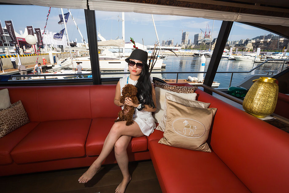 Zhang Luyi sits with her dog inside a yacht at SO! Dalian.