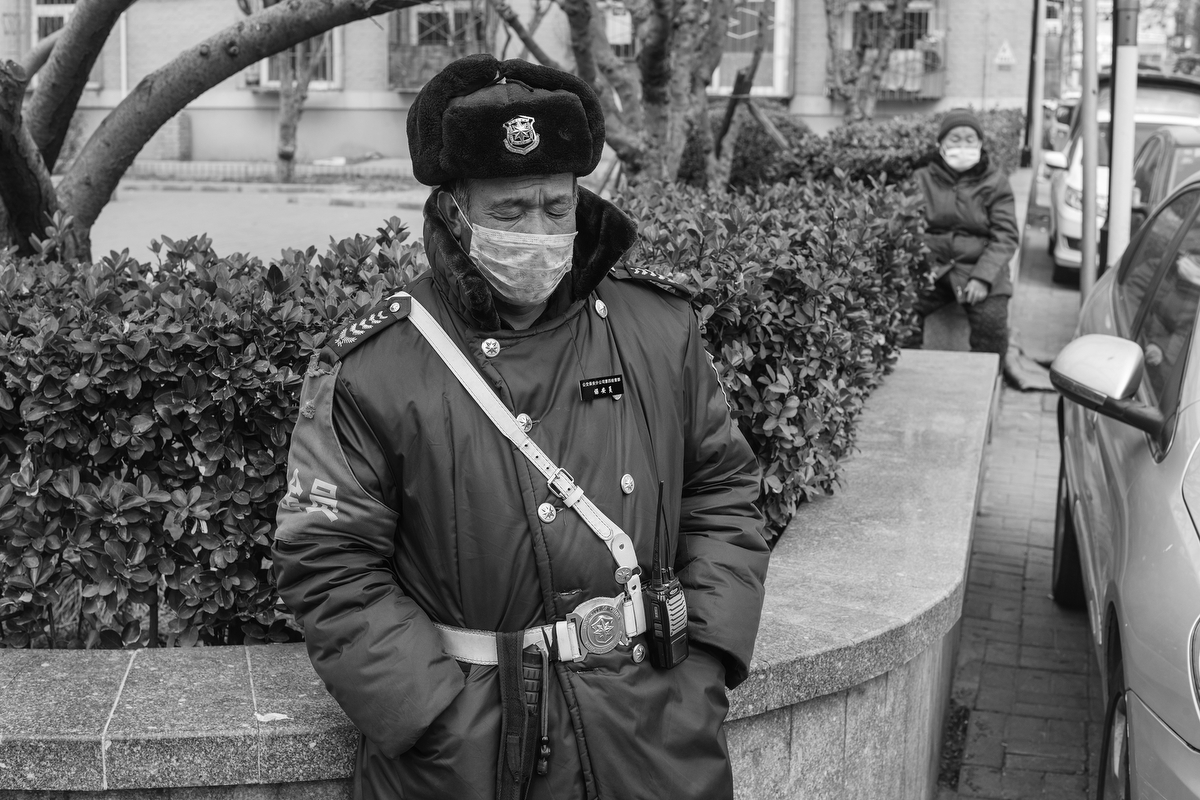 A police officer rests his eyes, on South Binhe Road, February 21, 2020.