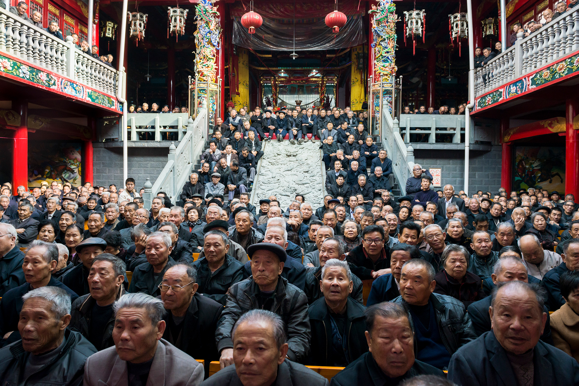 Elderly audience members watch Chinese opera at an ancestral shrine in Tingtian sub-district, November 25, 2013.