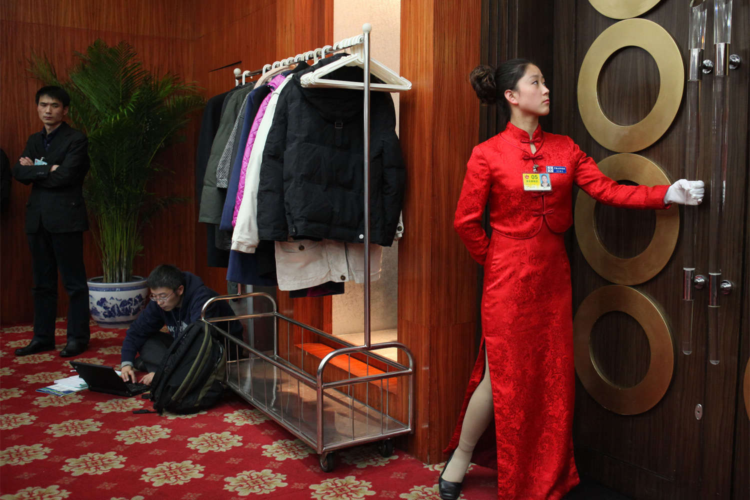 A waitress prepares to open the door for others to pass through at the Capital Hotel, March 4, 2011.