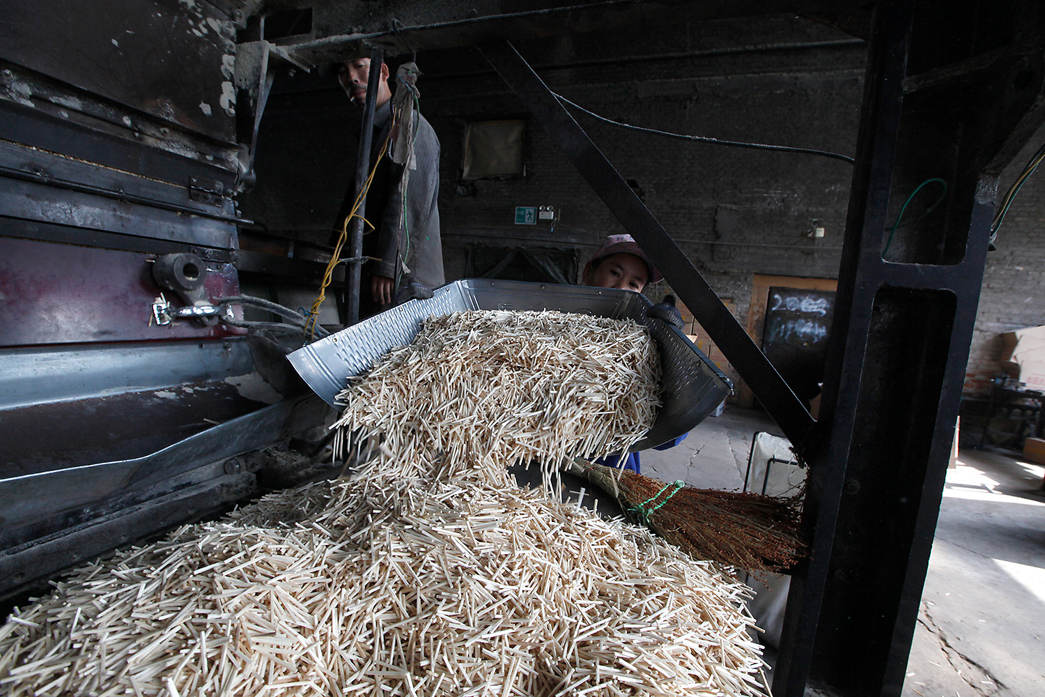 A worker processes matches that have just been cut. Most of these machines are so old that they often break down and need frequent repairs.