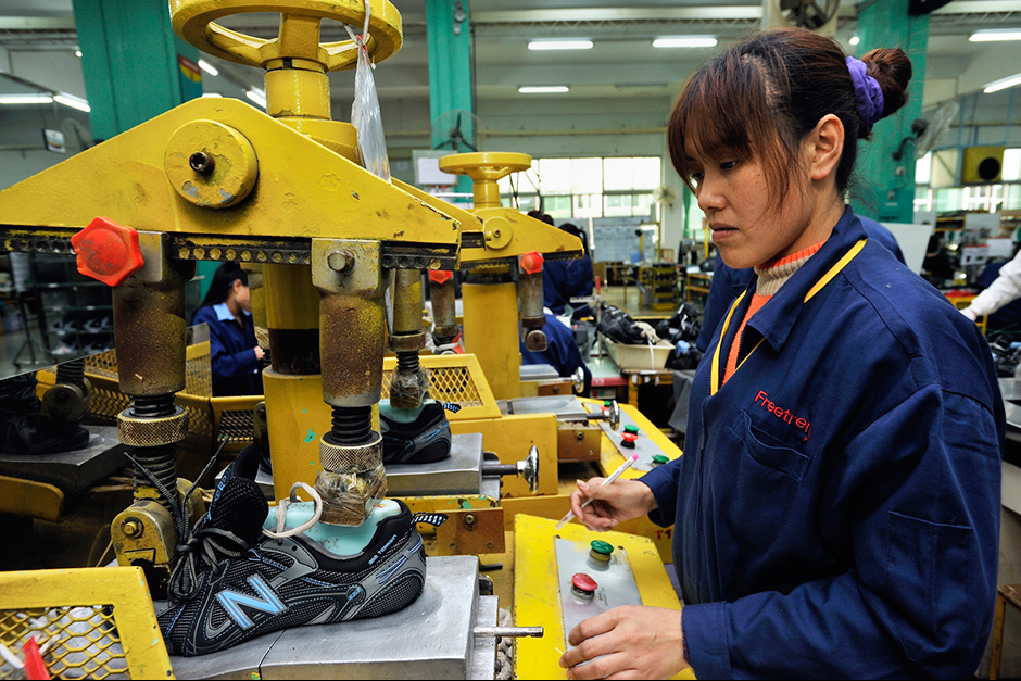 Zhao Meifang’s sister-in-law, Xu Xiaoying, works the factory line at the Freetrend New Balance plant.