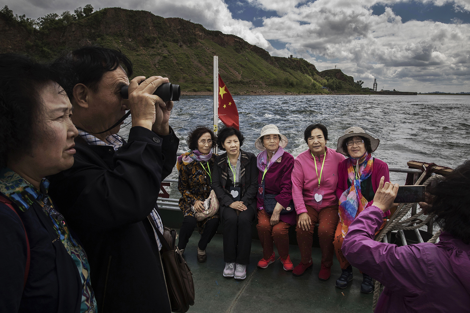 May 23, Chinese tourists ride in a boat on the Yalu river, which forms part of the border between China and North Korea. China has long been North Korea’s most important ally and trading partner, but relations are increasingly strained by continued missile testing and provocations by the regime of Kim Jong-un. (Kevin Frayer/Getty Images)