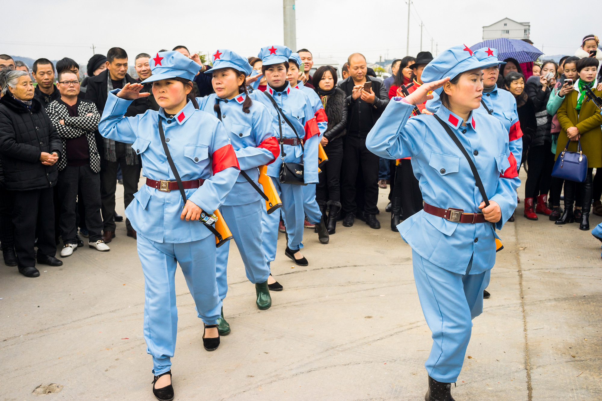 Women wearing replicas of Red Army uniforms perform at a Buddhist ceremony in Taoshan township, February 27, 2015. In order to gain government approval for the ceremony, the organizer added political propaganda elements to the event proposal.  