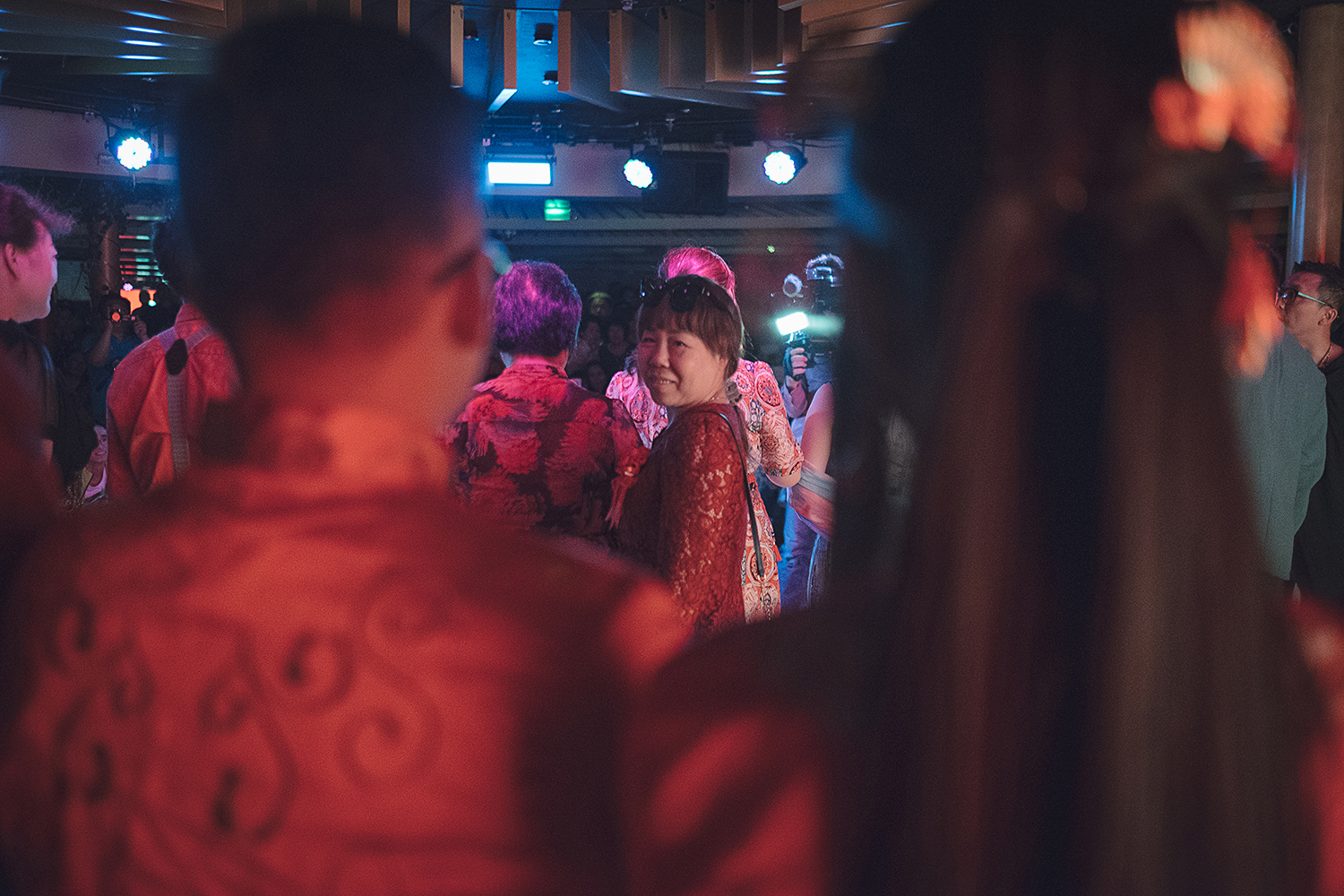 June 15, Mrs. Zheng looks back at her transgender son, Chen Zhichao, and his bride, Yang Jieli, during a LGBTQ group wedding ceremony on a cruise sailing between China and Japan. The wedding was part of a four-day event organized annually by a Chinese NGO in an effort to help LGBTQ people and their families better understand and support one another. (Yuyang Liu/ChinaFile)