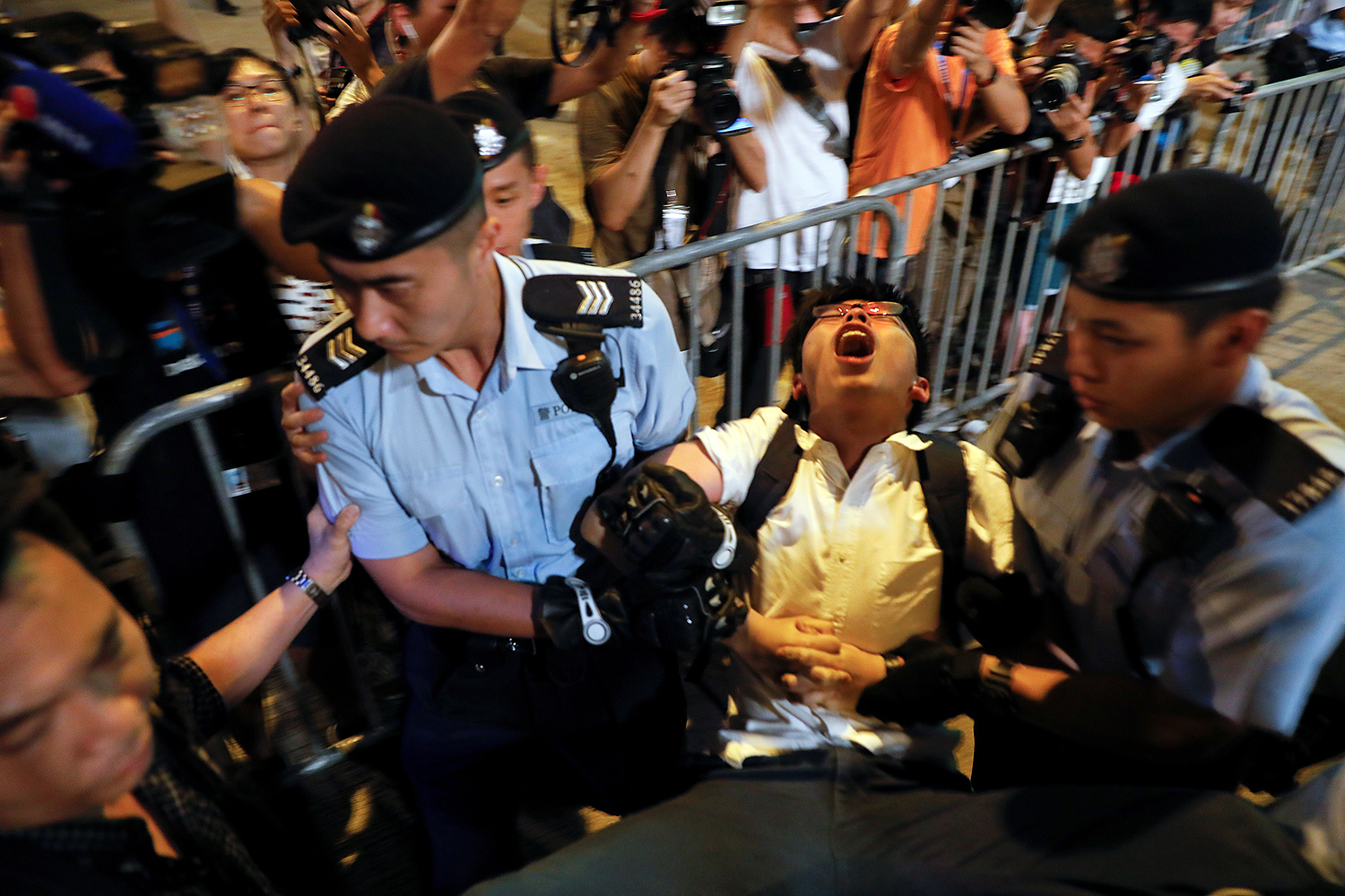 June 28, student protest leader Joshua Wong shouts as he is carried by policemen while protesters are arrested at a monument commemorating the city’s handover from British to Chinese rule, a day before Chinese President Xi Jinping is due to arrive to celebrate the handover’s 20th anniversary, in Hong Kong. In August, Wong, Nathan Law, and Alex Chow were sentenced to prison for six to eight months in connection with their participation in 2014’s “Umbrella Movement.” (Damir Sagolj/Reuters)