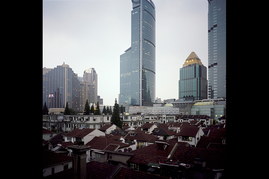 A traditional Shanghai <em>longtang</em> (alleyway) neighborhood along Weihai Road was granted historic landmark status and is protected even as development continues all around it.