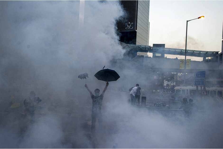 A pro-democracy demonstrator gestures after police fired tear gas towards protesters. (Photo by Xaume Olleros/AFP/Getty Images)