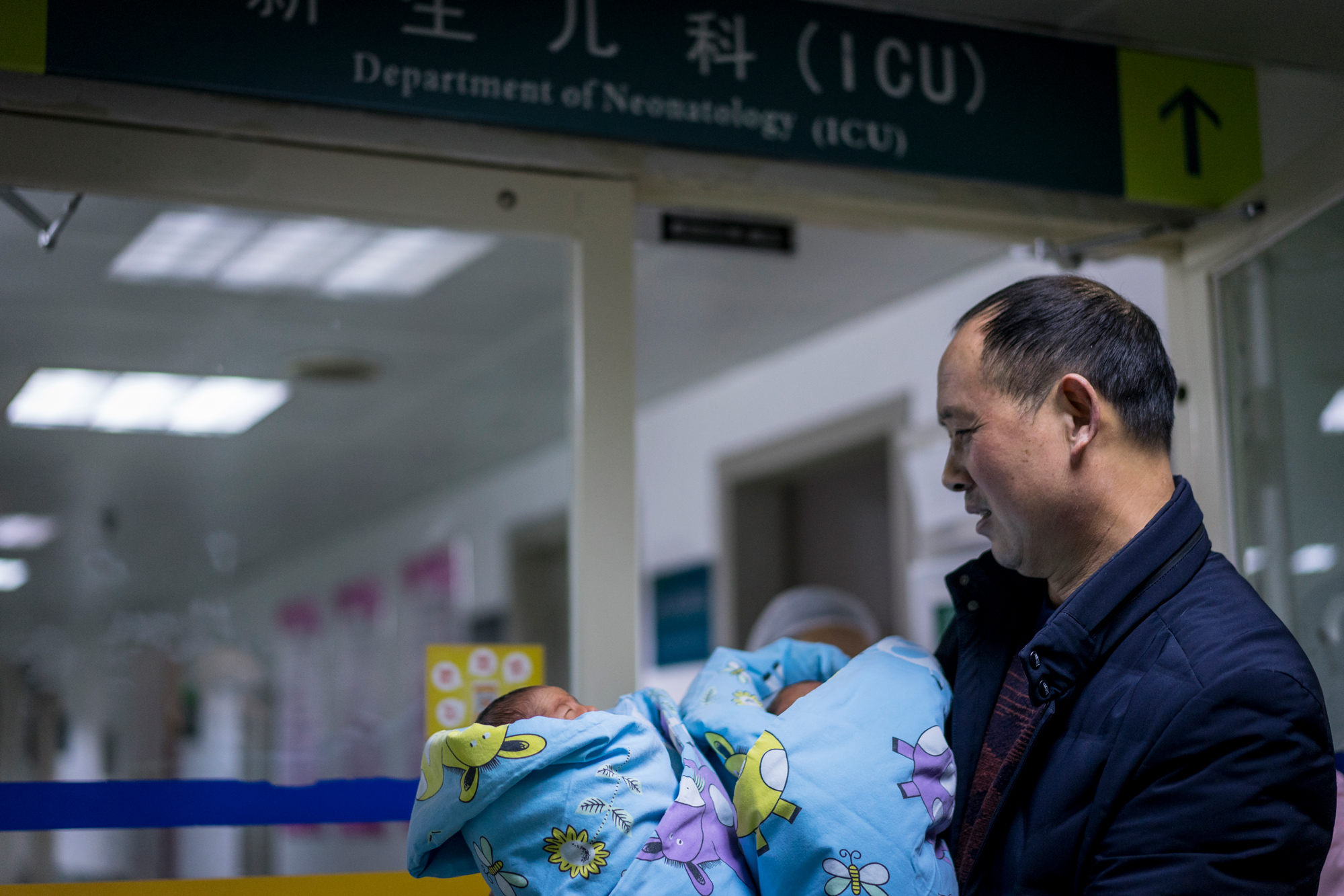 Because the twins were premature, they had to stay in incubators for several days. Fangguo finally gets to hold his children for the first time, December 17, 2017. 