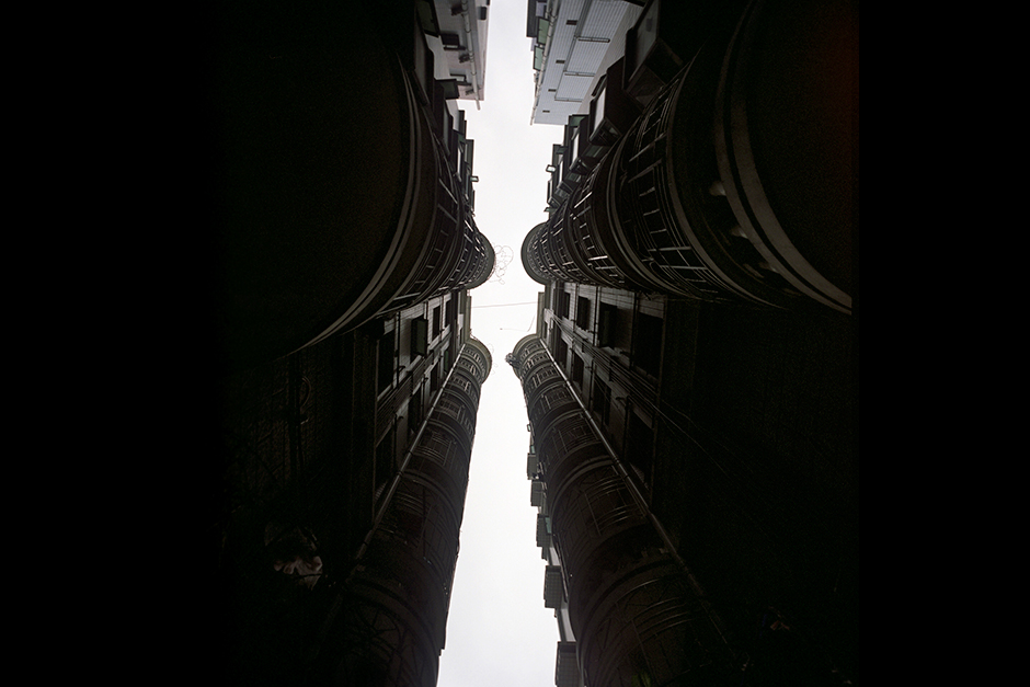 Extremely narrow alleys between buildings are common in urban villages, such as in this scene in Gangxia West Village. Here the buildings on each side are referred to as “handshake” buildings. These narrow alleys are fire safety concerns and are not in compliance with building code. But housing is more complex than building codes and blueprints.