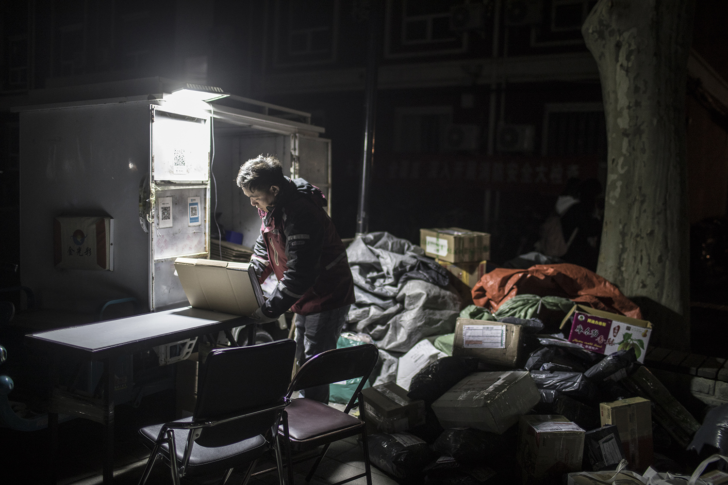 November 31, 31-year-old delivery man Pan Yabei sorts packages at Beijing Youth Politics College. Pan’s workload is heavy after Alibaba’s Singles’ Day sale. He has been working at the school for nine years but says he will have to leave Beijing soon because the home he rents is considered “unsafe” and he has been urged by authorities to move out. He says he can’t find another affordable place to stay. (Feng Haiyong/Tencent Guyu Project)
