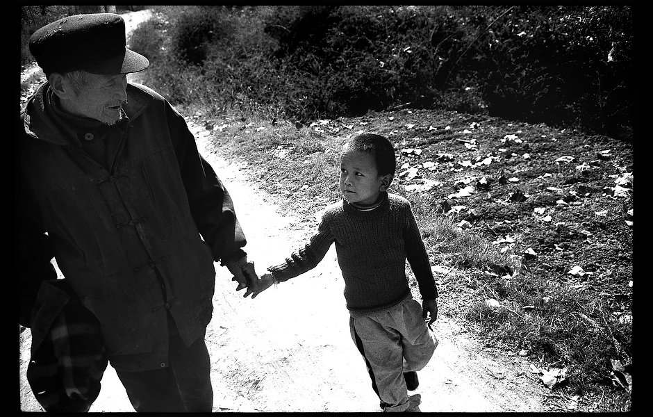 Since his father's death, Xiao Wang has been taken to school by his grandfather. Like AIDS, hepatitis B is spread from mother to child, infected needles, and unprotected sex. Unlike AIDS, a safe and effective vaccine exists, but inadequate education and a social veil of silence have resulted in the infection of as many as 400 million people worldwide. Henan, China