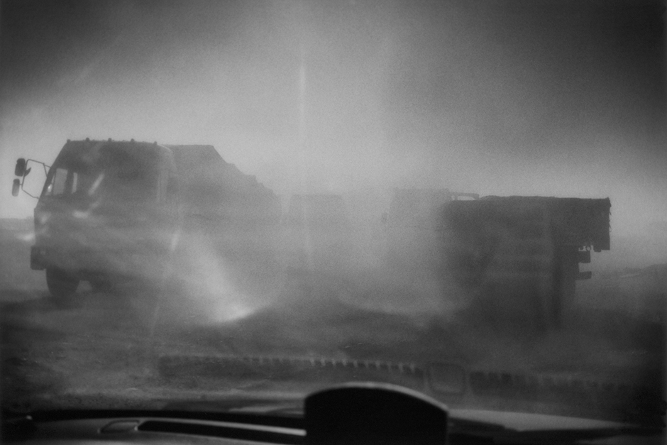 Dust from truck traffic through an industrial zone on National Highway 110 in Ningxia province.