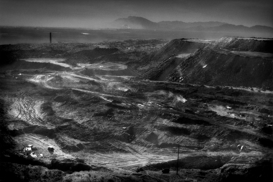 Open-pit coal mine on the back side of a Buddhist temple mountain in Laoshidan, Inner Mongolia. China produces more coal than the United States, the European Union, and Japan combined, and China consumes three times as much coal as the U.S.