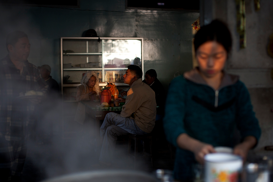 Customers sit at a riverside cafe near the banks of the Irrawaddy River, which is the source of much trade and life in Myanmar.
