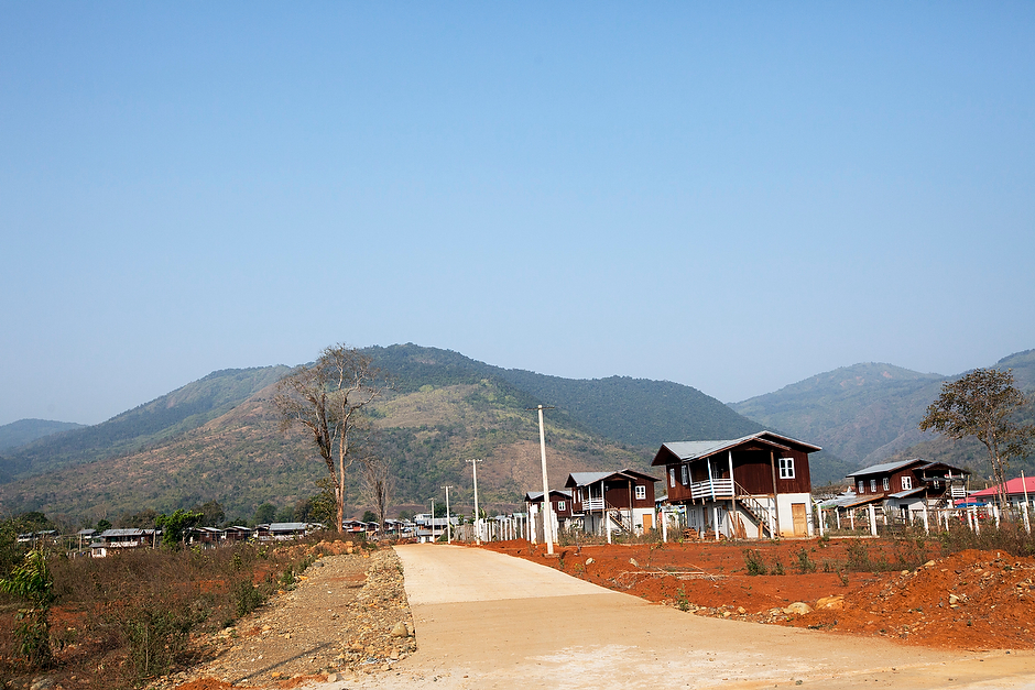 Simple two-story homes stand in neat rows at the model resettlement camp of Aung Myin Thar. The resettlement camp, which contains about two dozen homes, was built to house the villagers of Tang Phare.