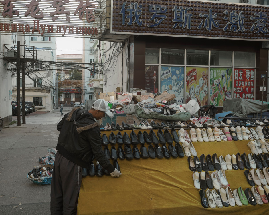 A shoe peddler sets up his wares in the city center of Heihe where the city street transforms into a huge market for Russian customers arriving from Blagoveshchensk, across the Amur River. Until a decade or so ago, it was a rural backwater, but a special economic zone was established in the city in the mid-90s, and the city has since grown to a population of close to 2 million.