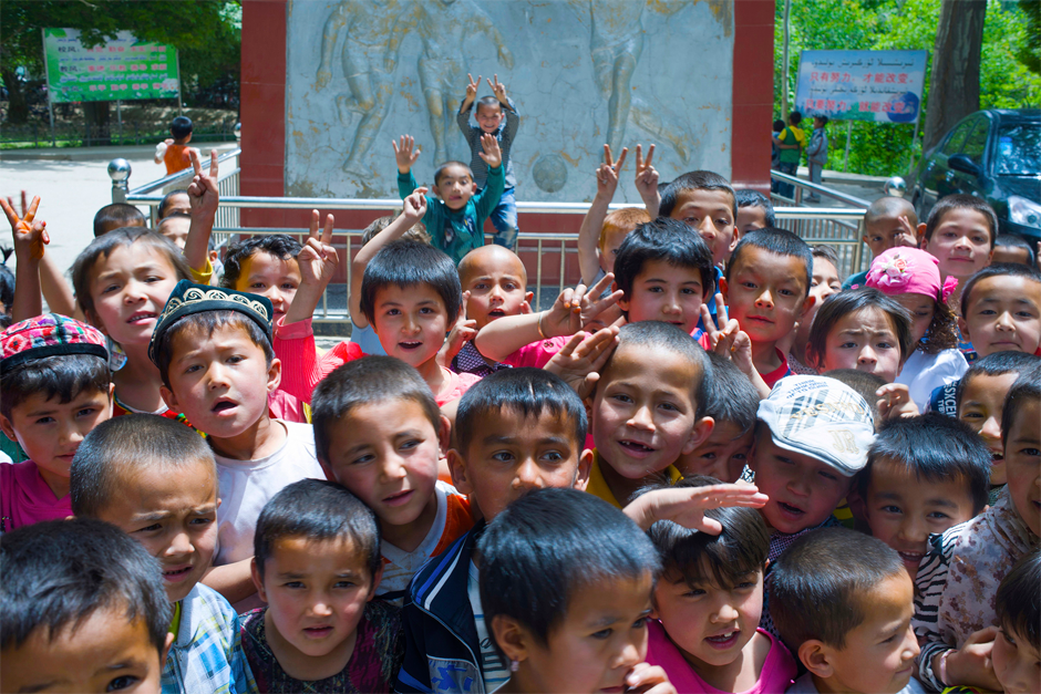 Elementary school children surround the statues of Hussein and Bawudun Musabayov, founding fathers of the town’s soccer tradition in Iksak, a town near the city of Artux. In 1874, the two brothers began an audacious plan to reform madrassa schools by incorporating elements of modern Western education, including training in soccer.