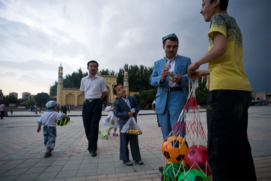 Every day on the plaza in front Kashgar’s Id Kah Mosque children play soccer and sell soccer balls.