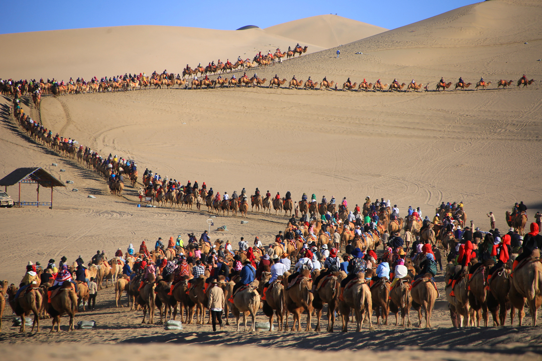 Tourists ride camels on Mingsha Mountain in Dunhuang, Gansu province, during China’s National Day holiday, October 2. Dunhuang, an oasis in the Gobi desert, was a major center of international trade, art, and commerce on the Silk Road, as well as a religious pilgrimage site. (The Yomiuri Shimbun/AP Photo )  
