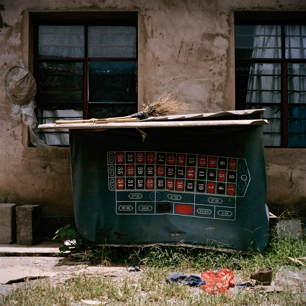 A casino table cover hangs from a shed outside an apartment for employees of the casino, in Boten, June 2011.