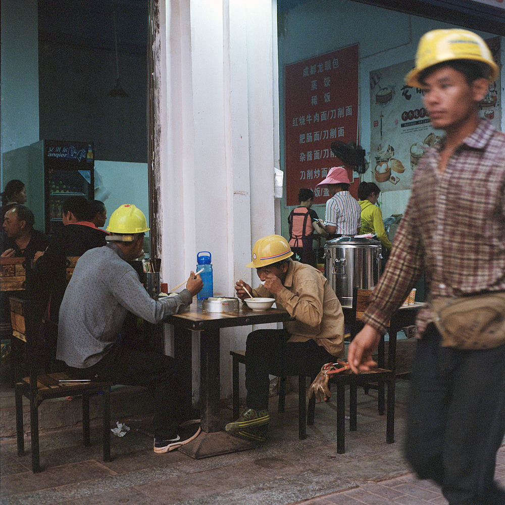 Chinese construction workers eat breakfast at a Sichuan restaurant in Boten, April 13, 2019.