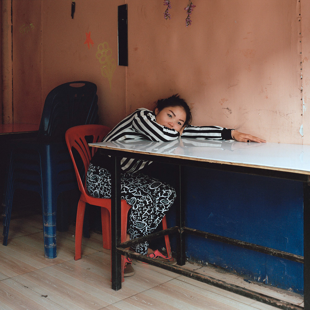 A Lao worker waits for customers at a restaurant, January 2016.