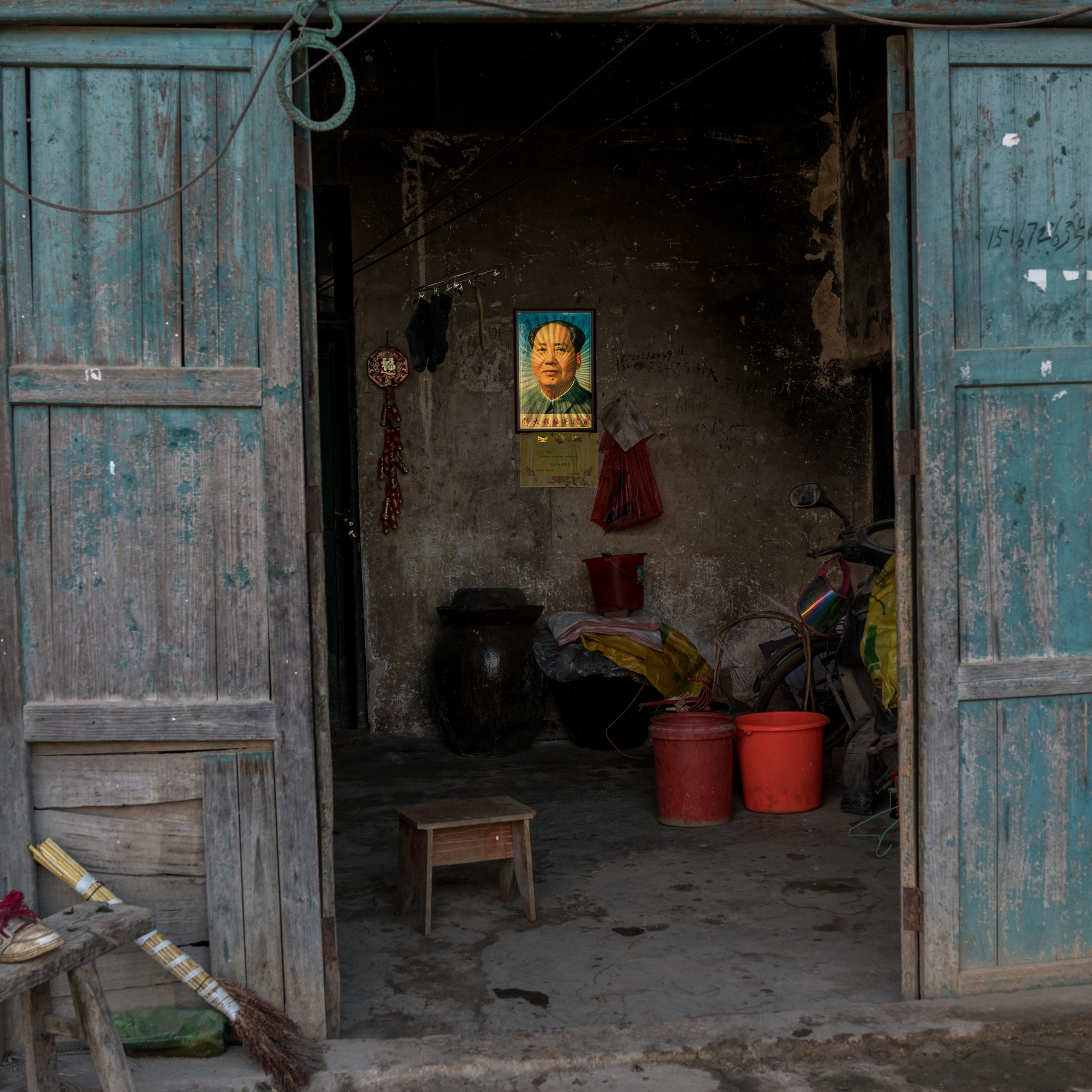 A holographic portrait of Mao Zedong hangs on the wall of a house in Shuinan village. Mao’s embrace of radical policies and violence led to the Cultural Revolution in which at least 1.5 million were killed in collective killings pervasive across the Chinese countryside.