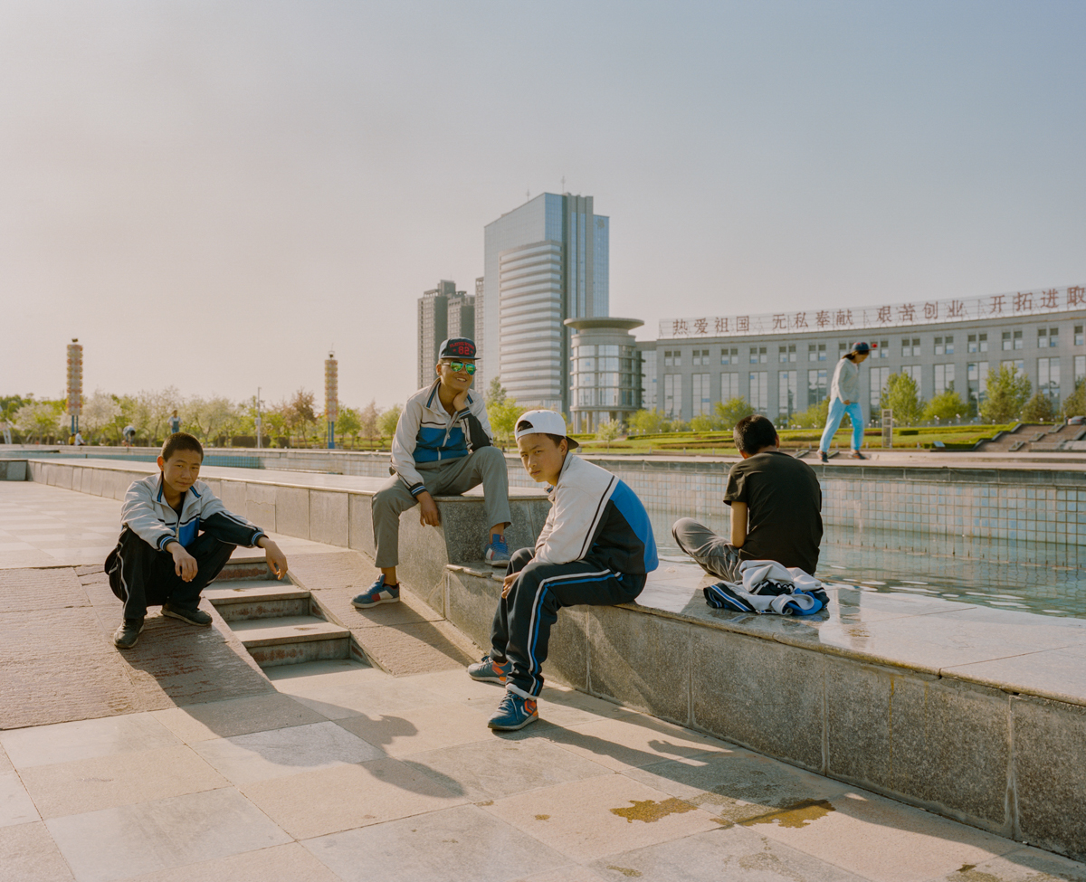 Teenagers socialize after school at a park in the city of Shihezi in northern Xinjiang, May 2017.