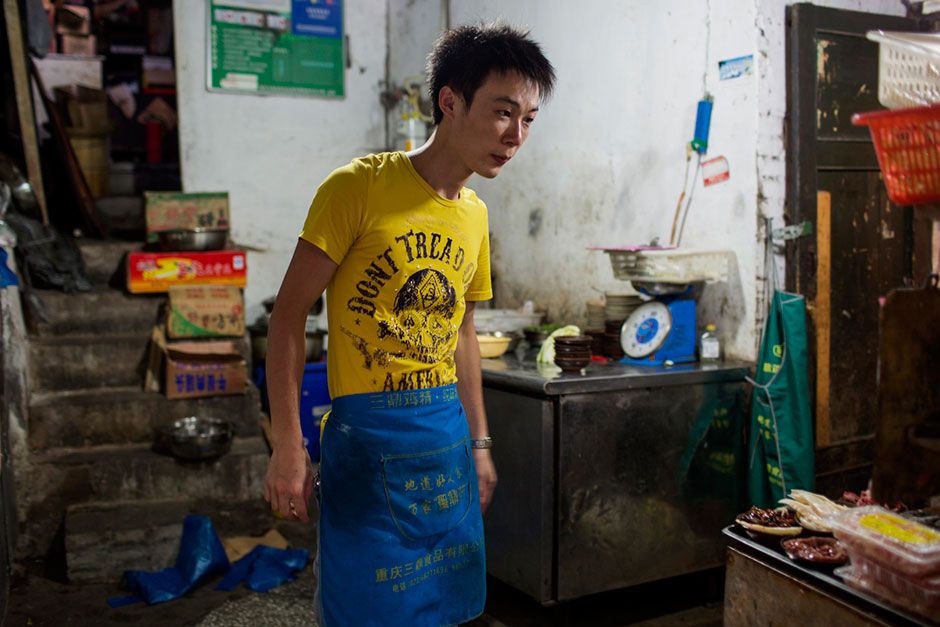 A cook inside the kitchen of An Pang Hotpot in an alley above Tiyu Road.