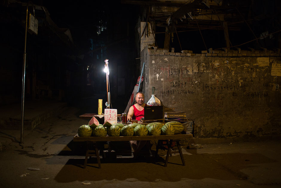 A watermelon seller waits for customers at the bottom of Shibati.
