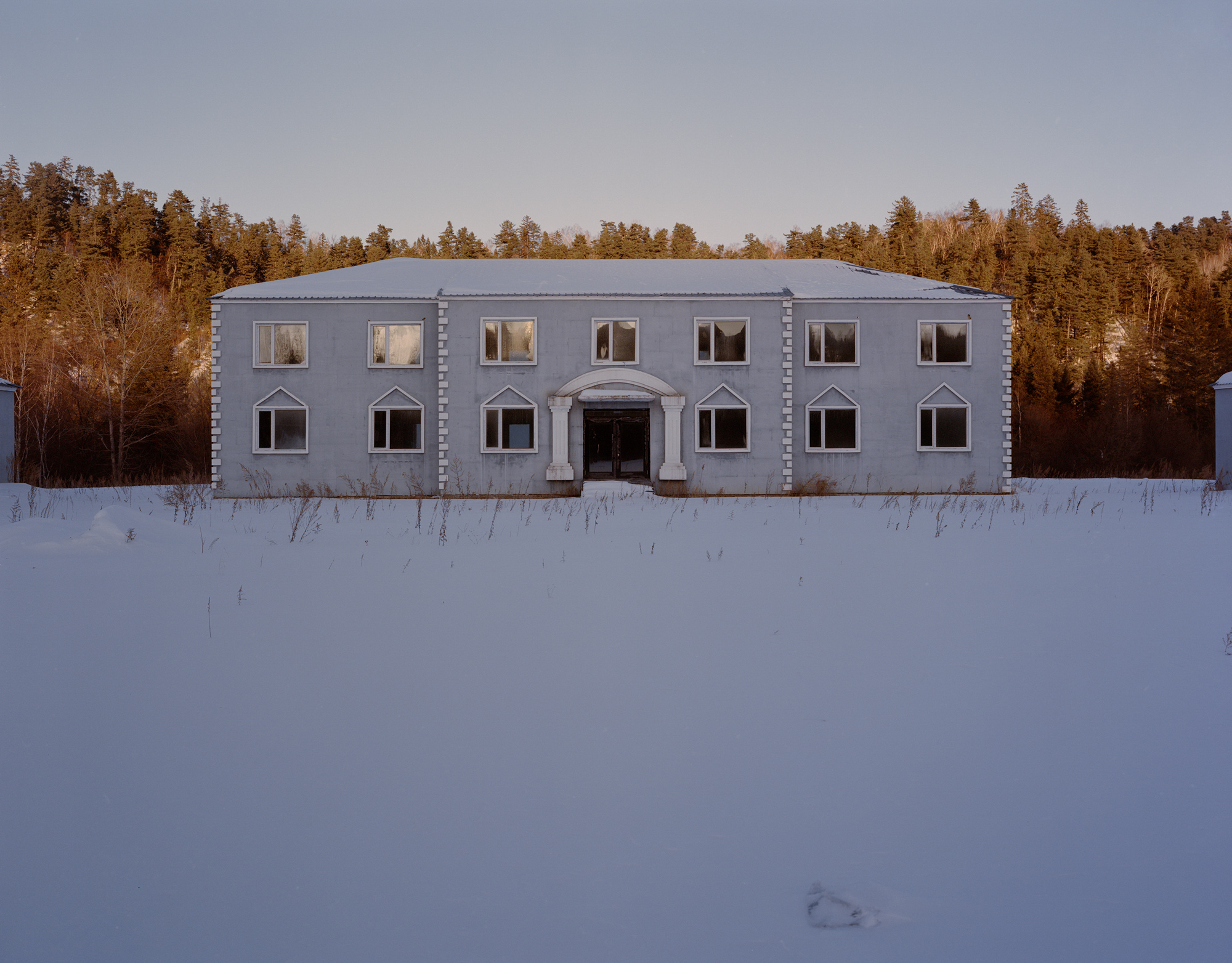 An empty office building of the local Forestry Bureau in Yichun. Beginning in 2014, China banned commercial logging in state-owned natural forests in Heilongjiang province. As a result, this office building was left unused after its construction was completed in 2013.