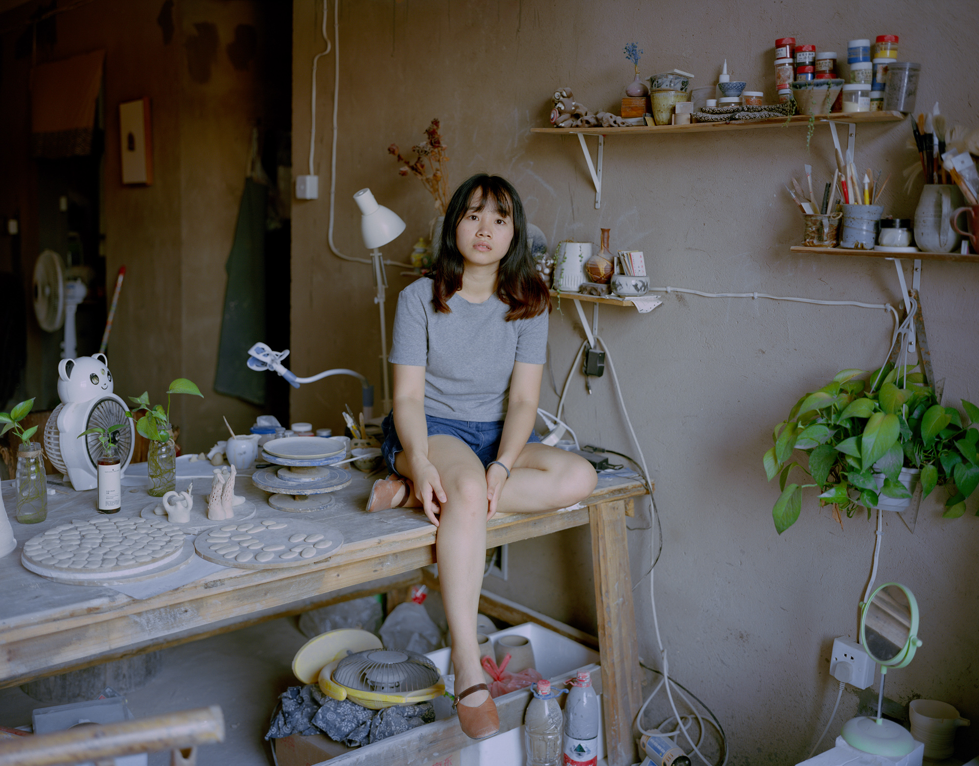 Liang Zhuanshan, a 24-year-old porcelain artist, sits in her studio in Jingdezhen. Despite the clay shortage, Jingdezhen has managed to rejuvenate its art and education industry. Studios and workshops have opened one after another in recent years, and have attracted many artisans.         