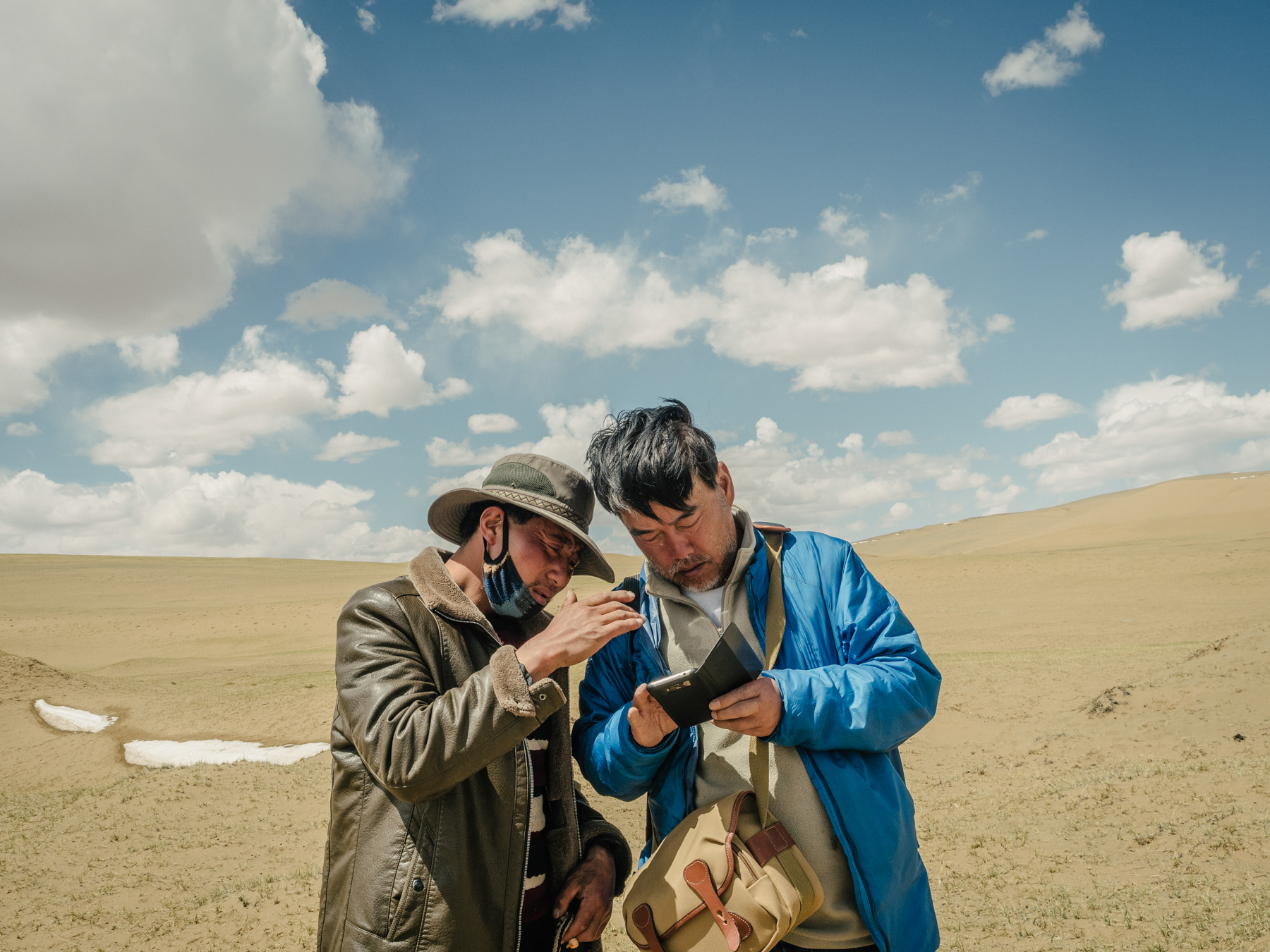 Yang and a Tibetan herdsman discuss their location on a satellite map, in Madoi county. “Although satellite imaging has documented the advance of these deserts above an altitude of 4,000 meters [13,000 feet],” Yang says, “there are rarely any expeditions to or studies of these newly formed deserts.” As far as he is aware, Yang is the only person who regularly conducts field studies in these areas to assess advancing desertification.