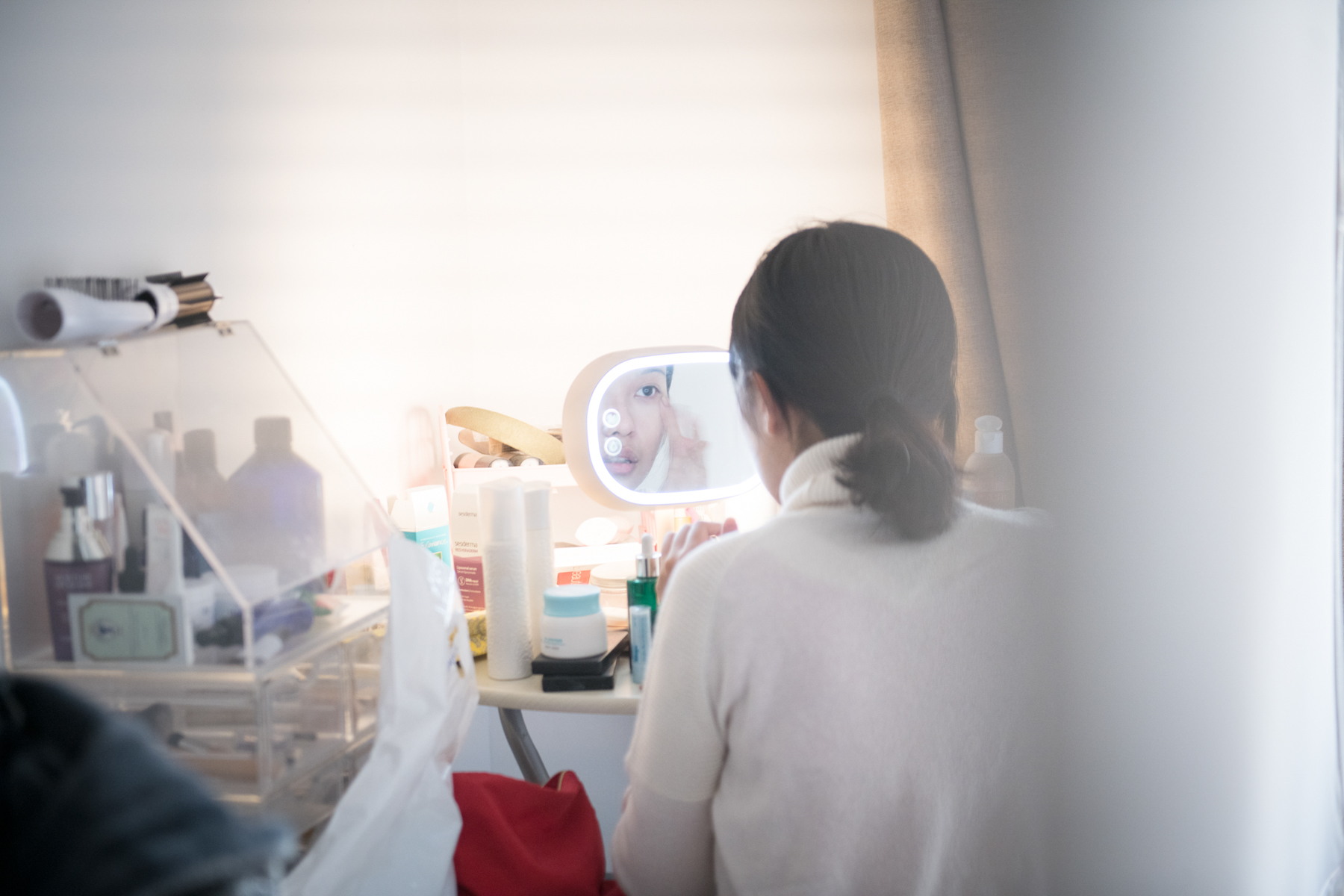Zhou applies makeup before being photographed, December 9. Originally from Wuhan, she moved to Beijing in 2011 to attend a performing arts school. The apartment she lives in recently raised its rent by 7 percent, but Zhou is too busy with her lawsuits to find a new place to live. 